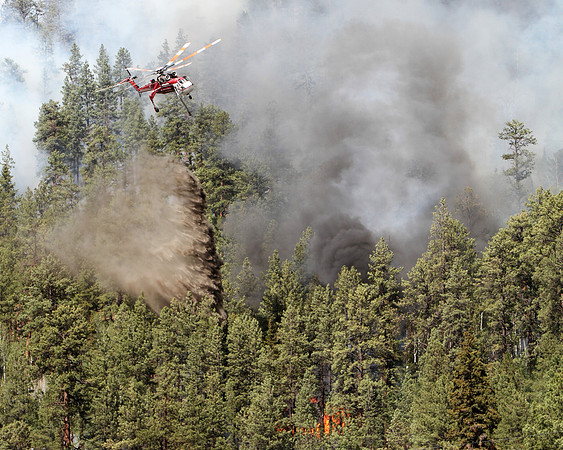 A Skycrane hits fires threatening homes in Greer