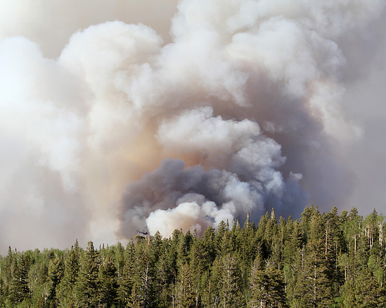 A massive helicopter is dwarfed by the column of the Wallow Fire