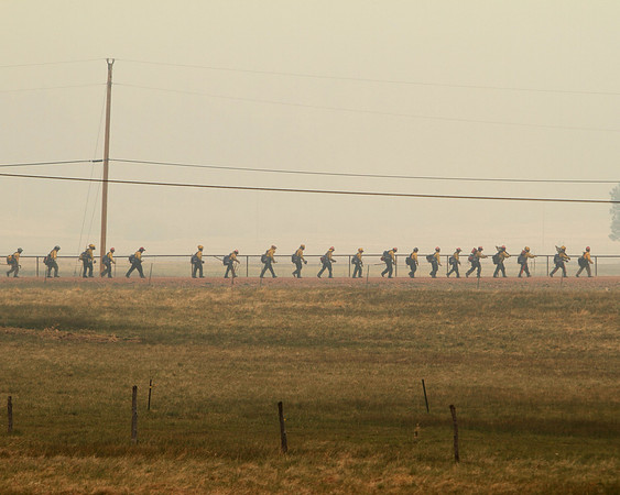 A Native American Handcrew returns to their bus after a long night on the Wallow Fire
