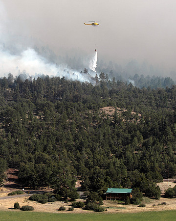 A helicopter does bucket work above South Fork