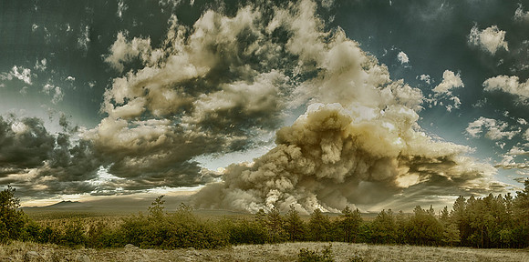 The smoke of the slide fire creates an image of a bearded man